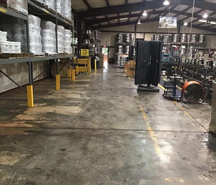Dry warehouse, concrete flooring, clean shelving