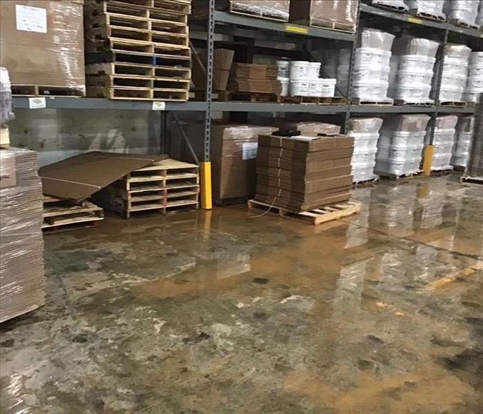flooded warehouse, shelving, water on concrete pallets