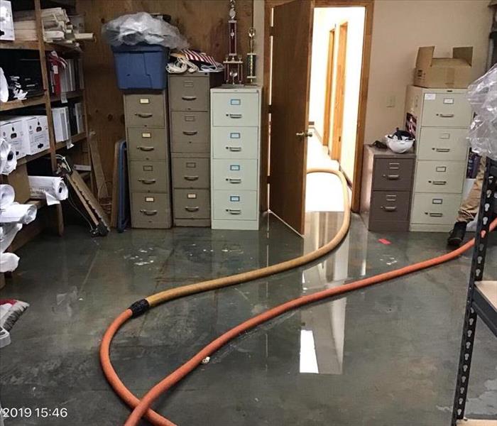 water on floor, hoses, filing cabinets, water damage