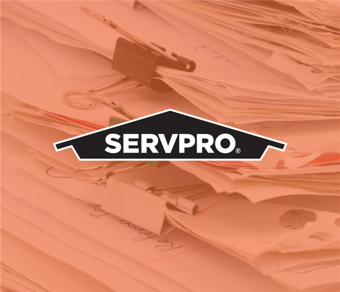 Stacked paperwork with logo overlay